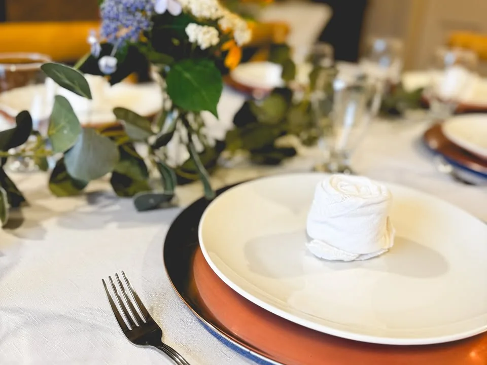 Formal place setting with flowers at a private event table.